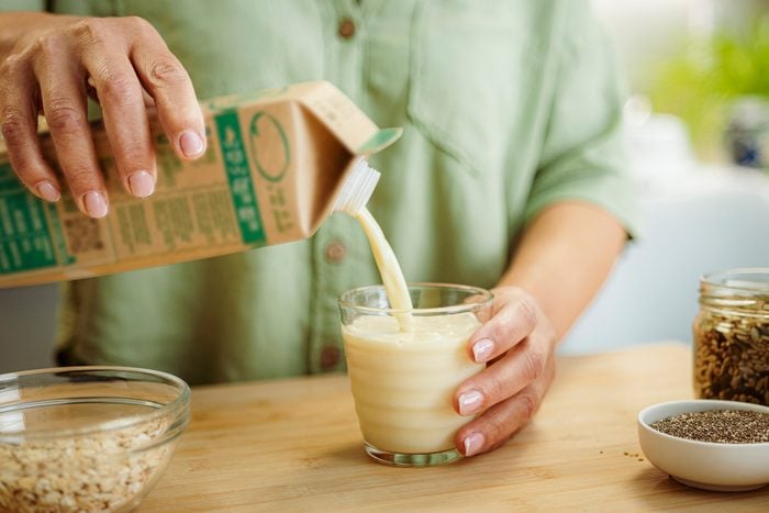 Woman pouring milk into a glass
