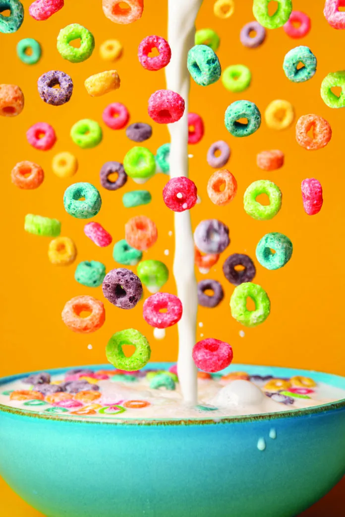 Milk and cereal poured in a bowl. Preparing breakfast, creative layout