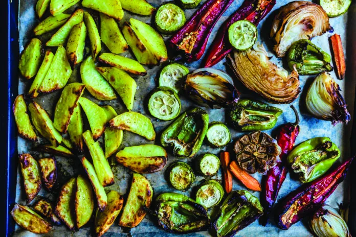 Overhead view of roasted vegetables on a baking tray