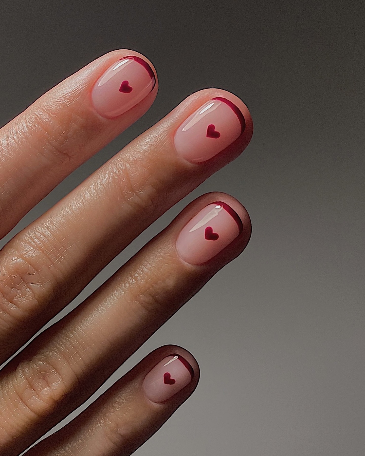 Red French manicure with red hearts.