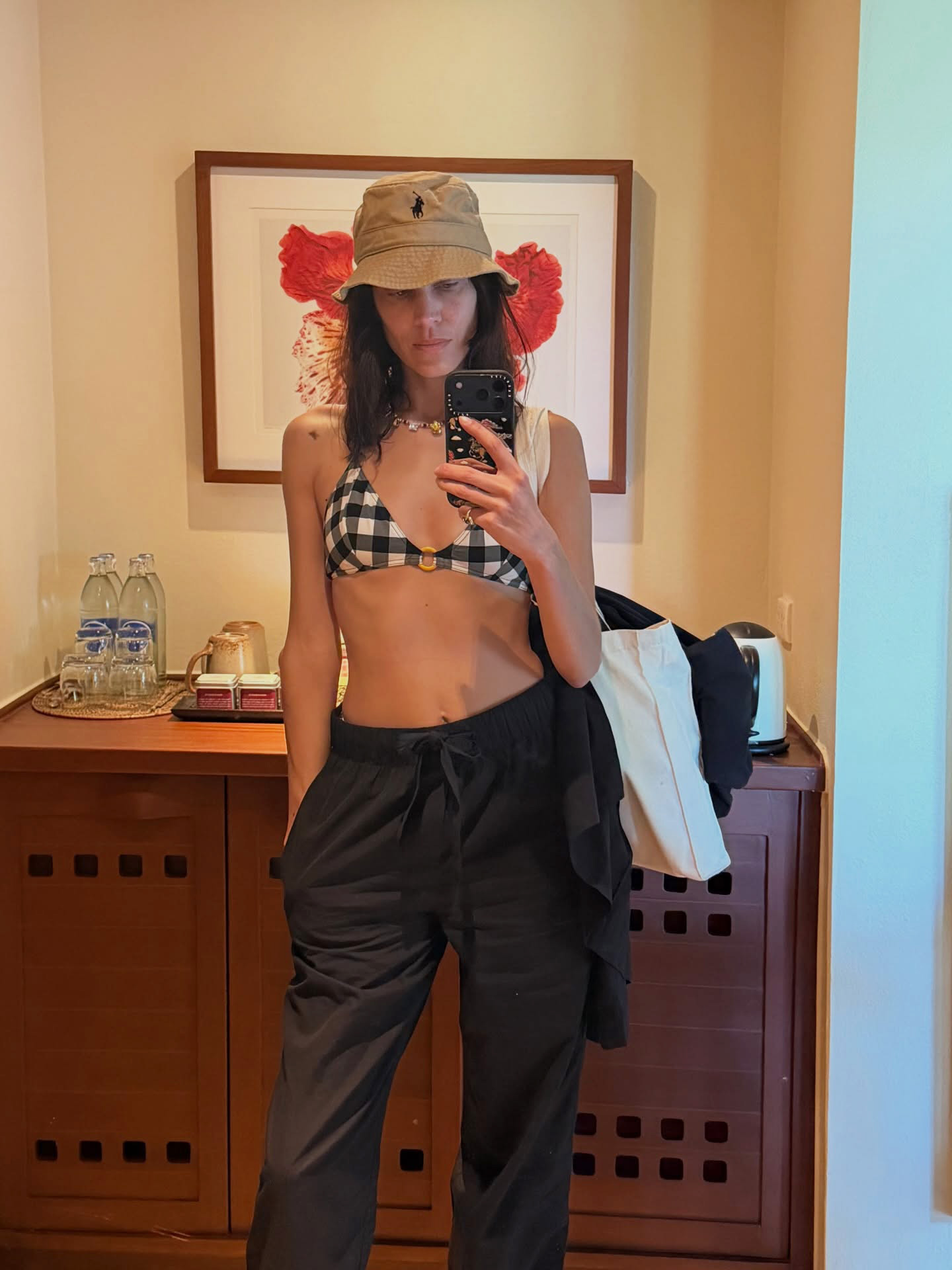 Alexa Chung wearing a Polo Ralph Lauren Cotton Chino Bucket Hat, gingham bikini, and black pull-on pants