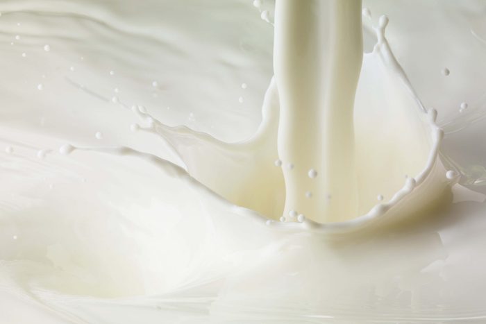 Full frame of Milk pour and splash close up