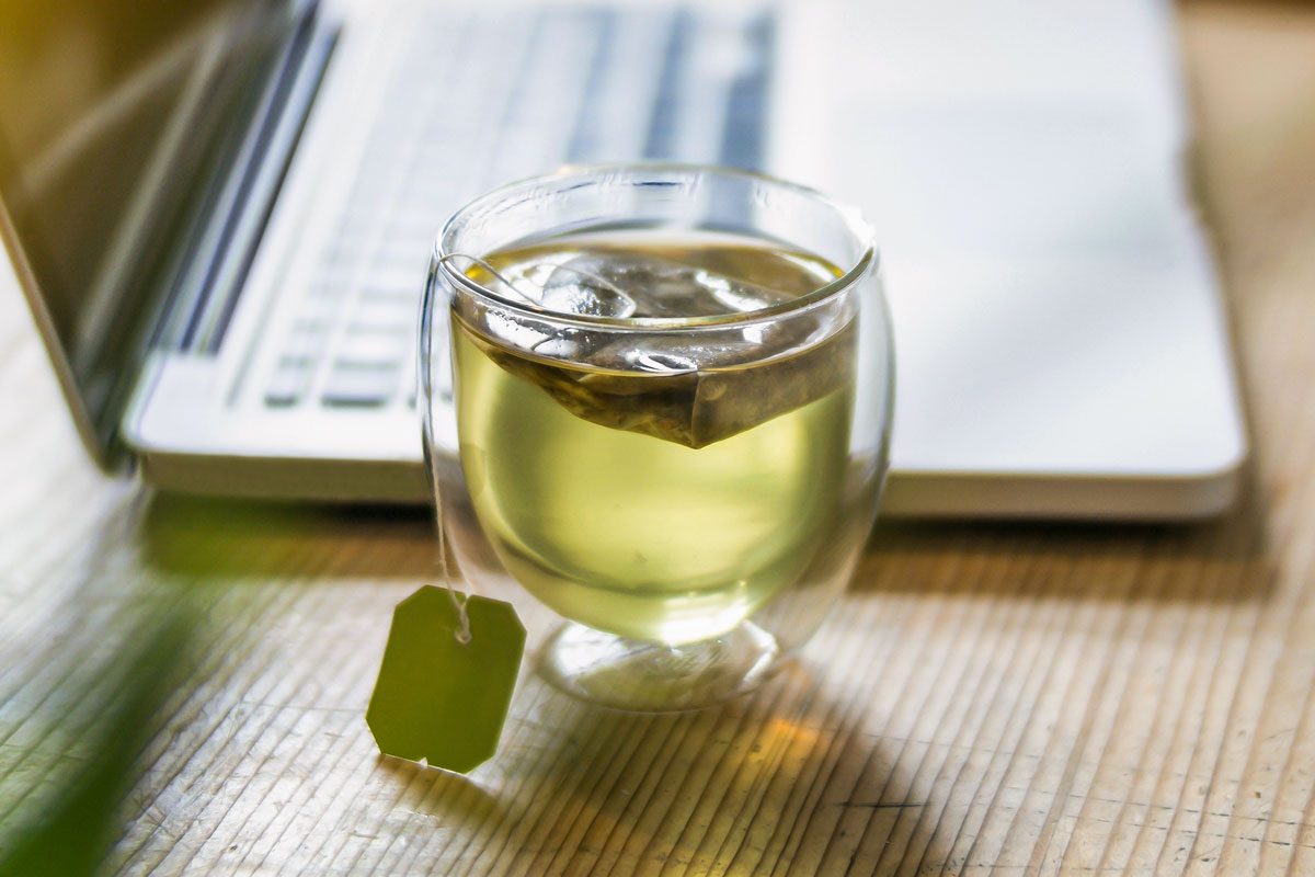 Glass Of Green Tea Beside Laptop