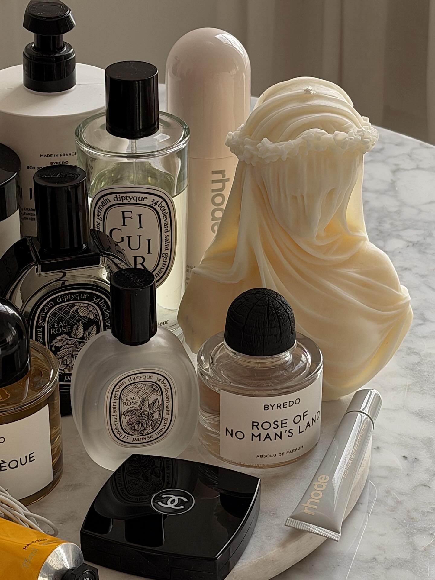 An image of a person's perfume and beauty product collection.