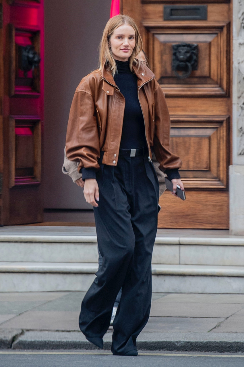 Rosie Huntington-Whiteley wearing a cognac leather jacket and black pants
