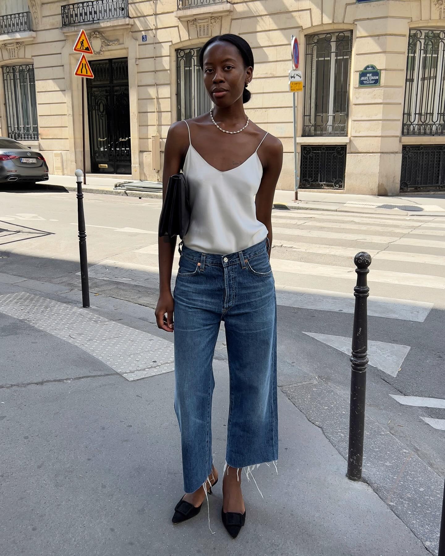 Influencer wearing jeans and a silky camisole.
