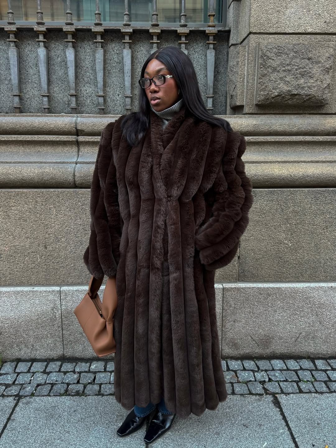 Woman wearing brown faux fur coat 2026.