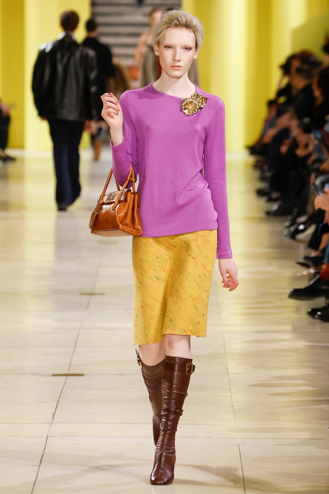 Miu Miu runway model wearing pastel knitwear.