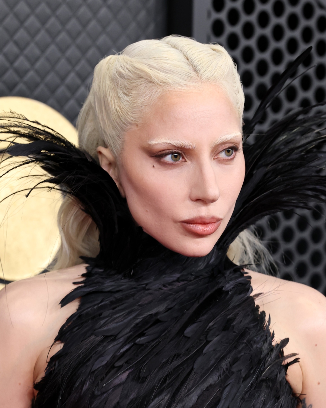 Lady Gaga with sculpted cheeks, smoky eyeliner, and bleached brows
