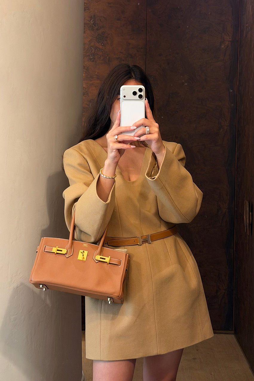 Bettina Looney wearing a camel Carven dress and an Hermes bag