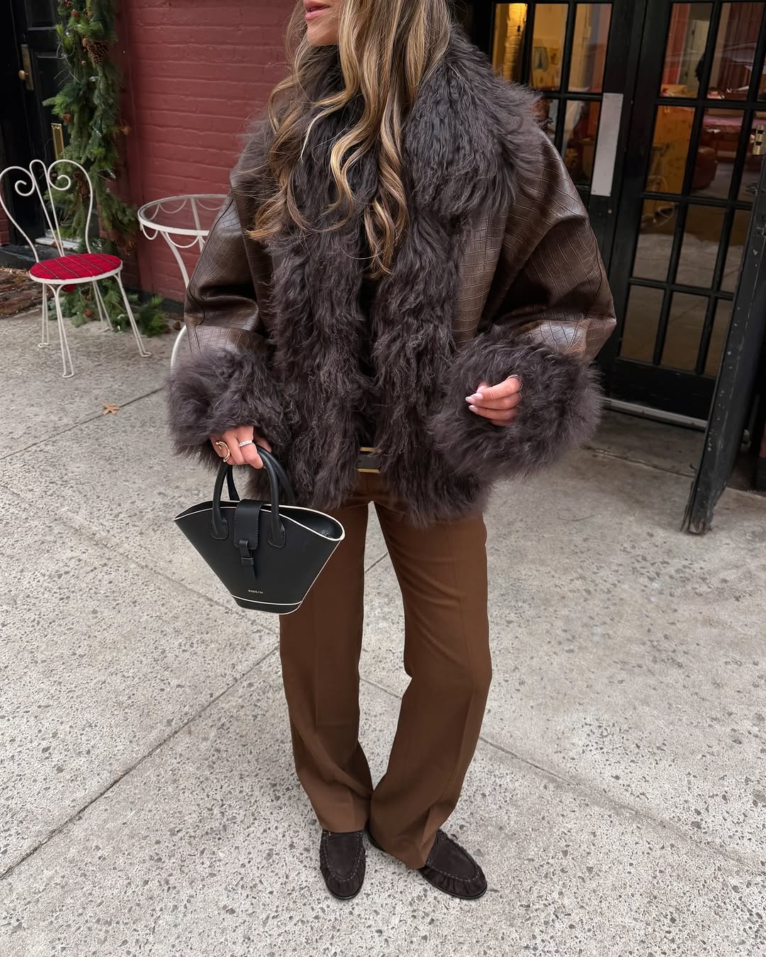 Woman wearing brown faux fur coat 2026.