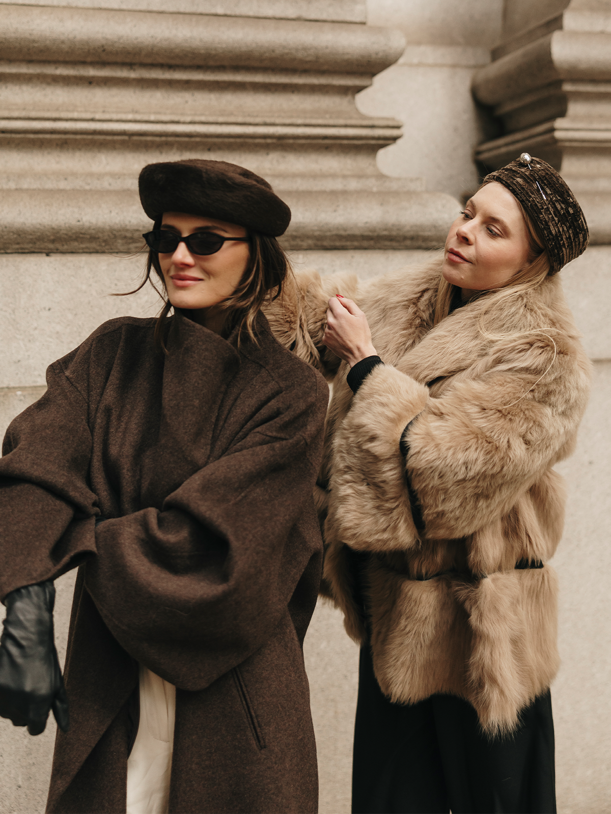 Photo of Gigi Burris and Coco Schiffer wearing pillbox hats.