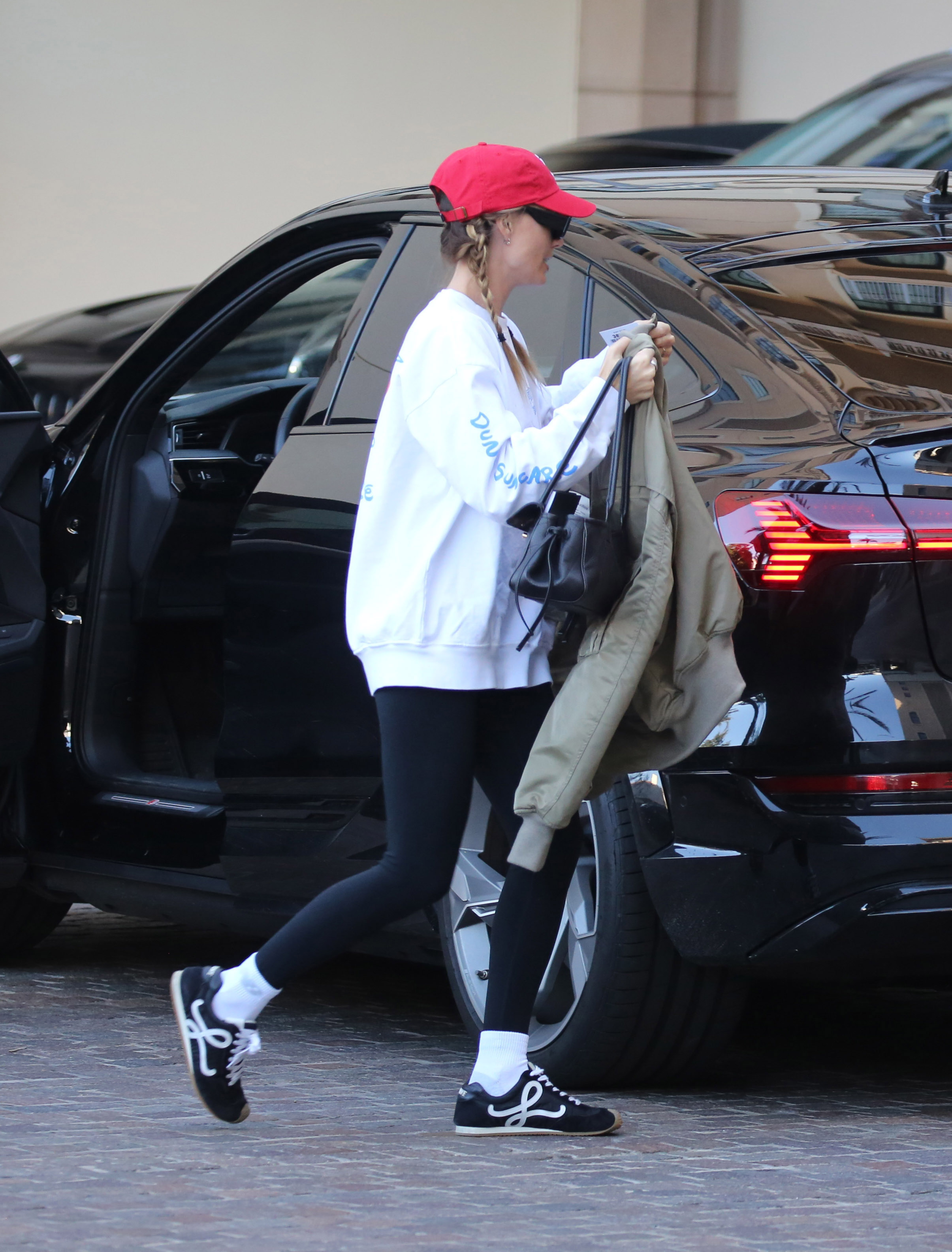 Margot Robbie wearing leggings with Loewe sneakers.