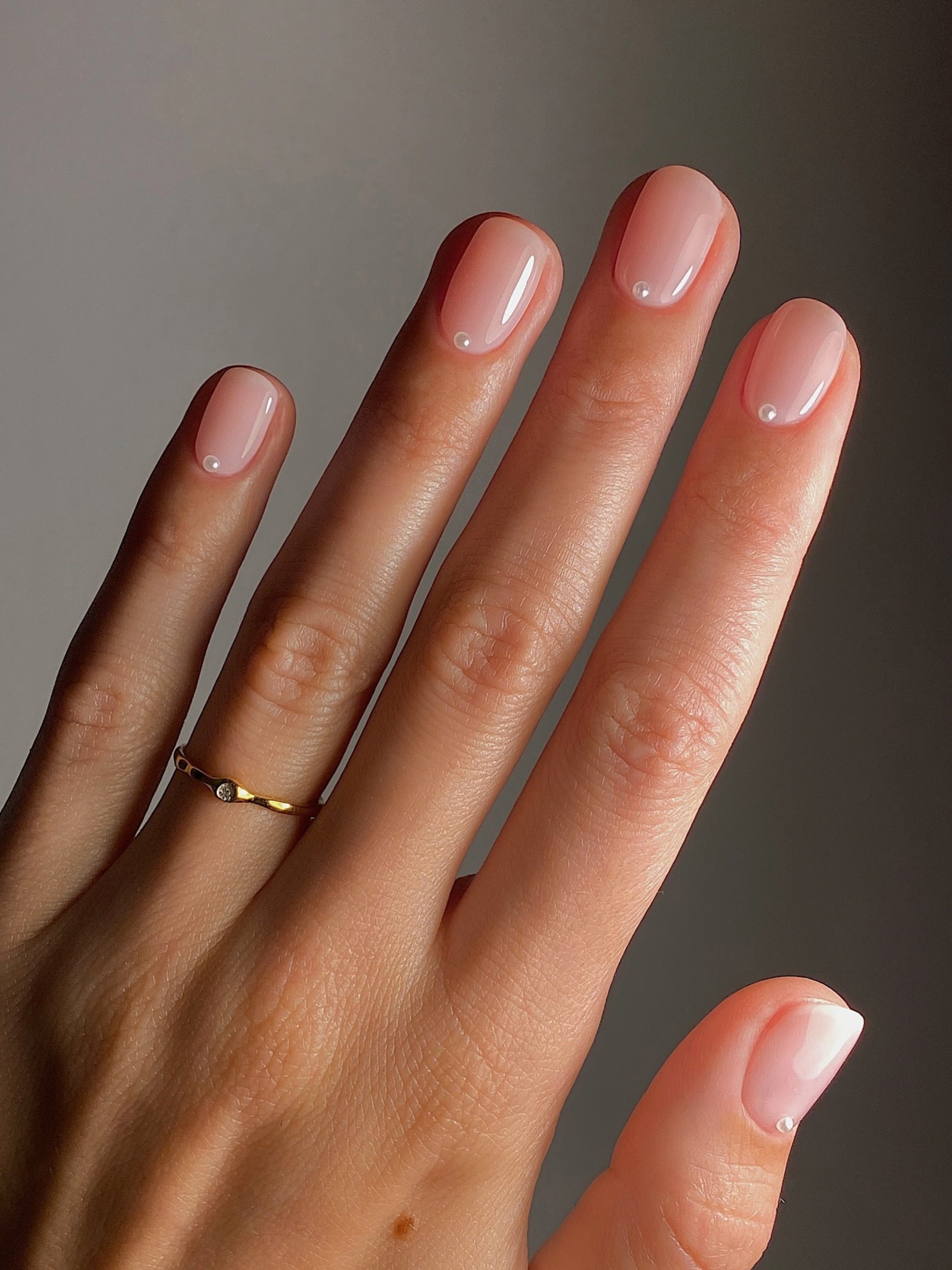 A pink manicure with pearl details by Mateja Novakovic.
