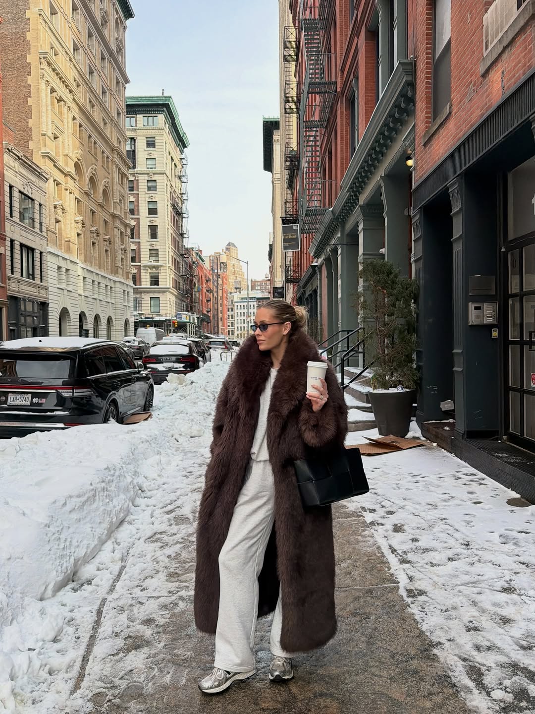 Woman wearing brown faux fur coat 2026.
