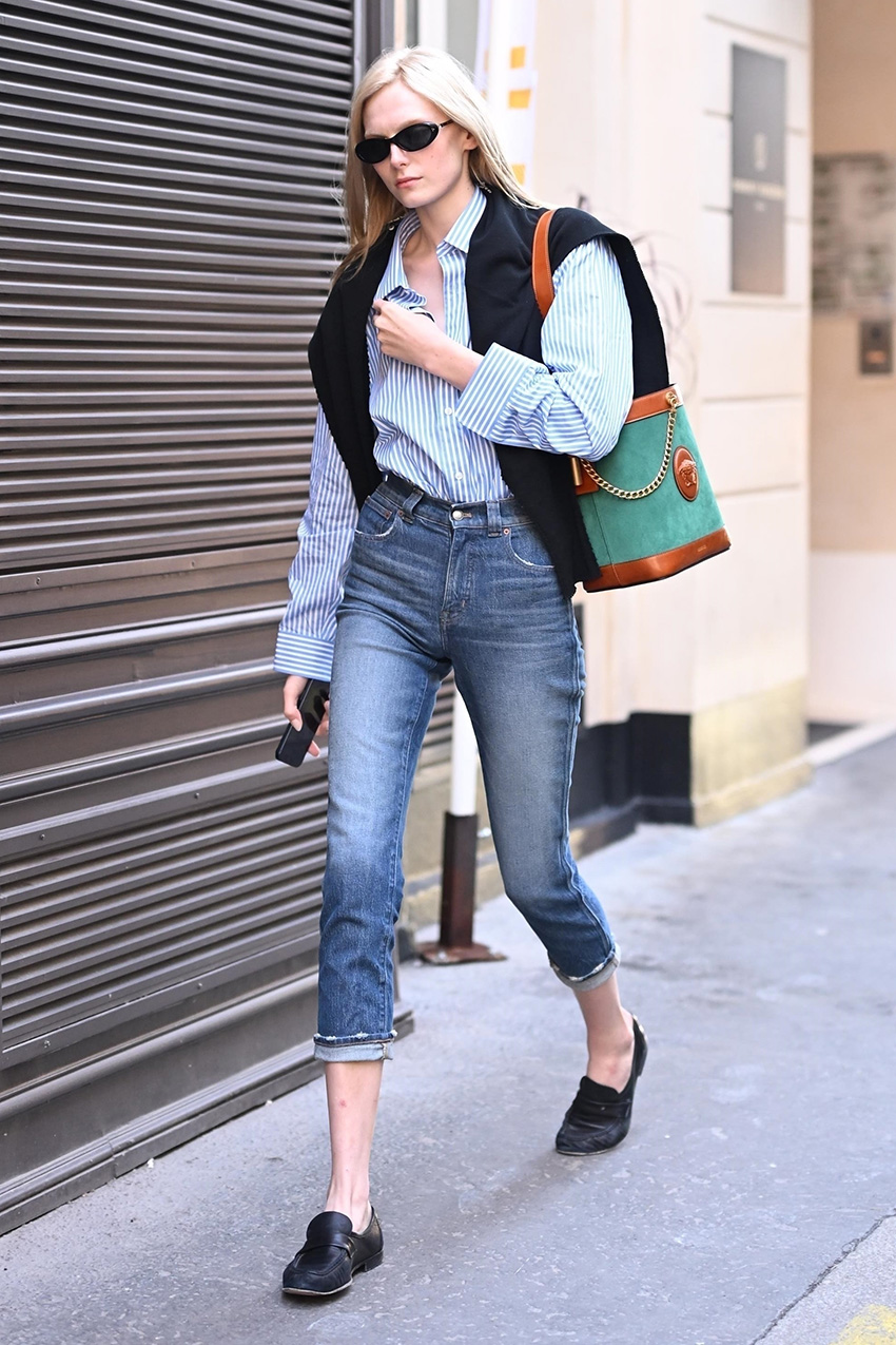 Model Alex Consani wearing cropped jeans and loafers in Paris