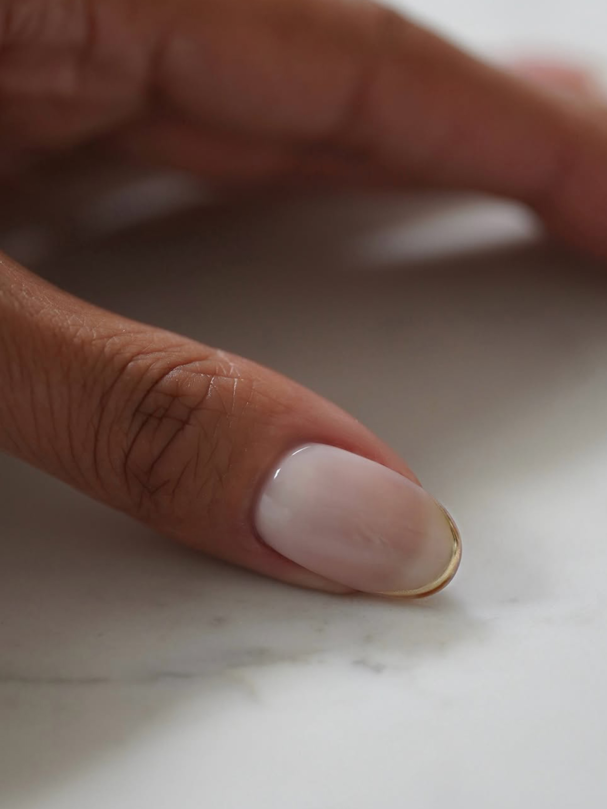 A short manicure with gold tips by Iram Shelton.