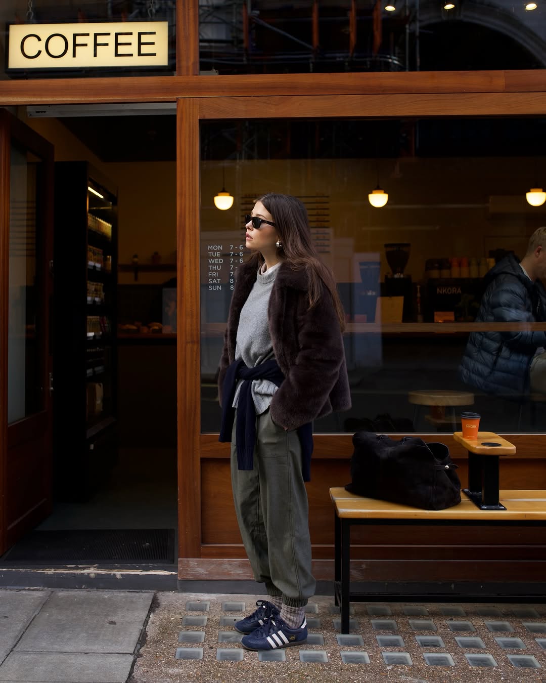 Woman wearing brown faux fur coat 2026.