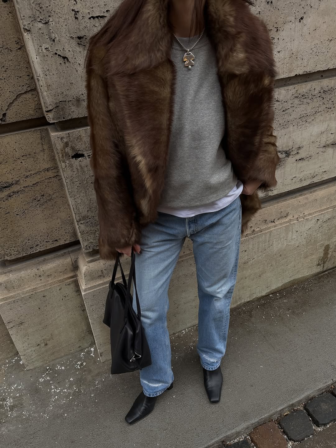 Woman wearing brown faux fur coat 2026.