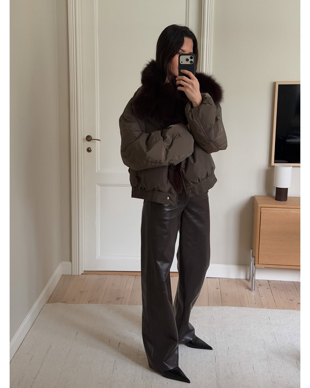 Woman wearing brown faux fur coat 2026.